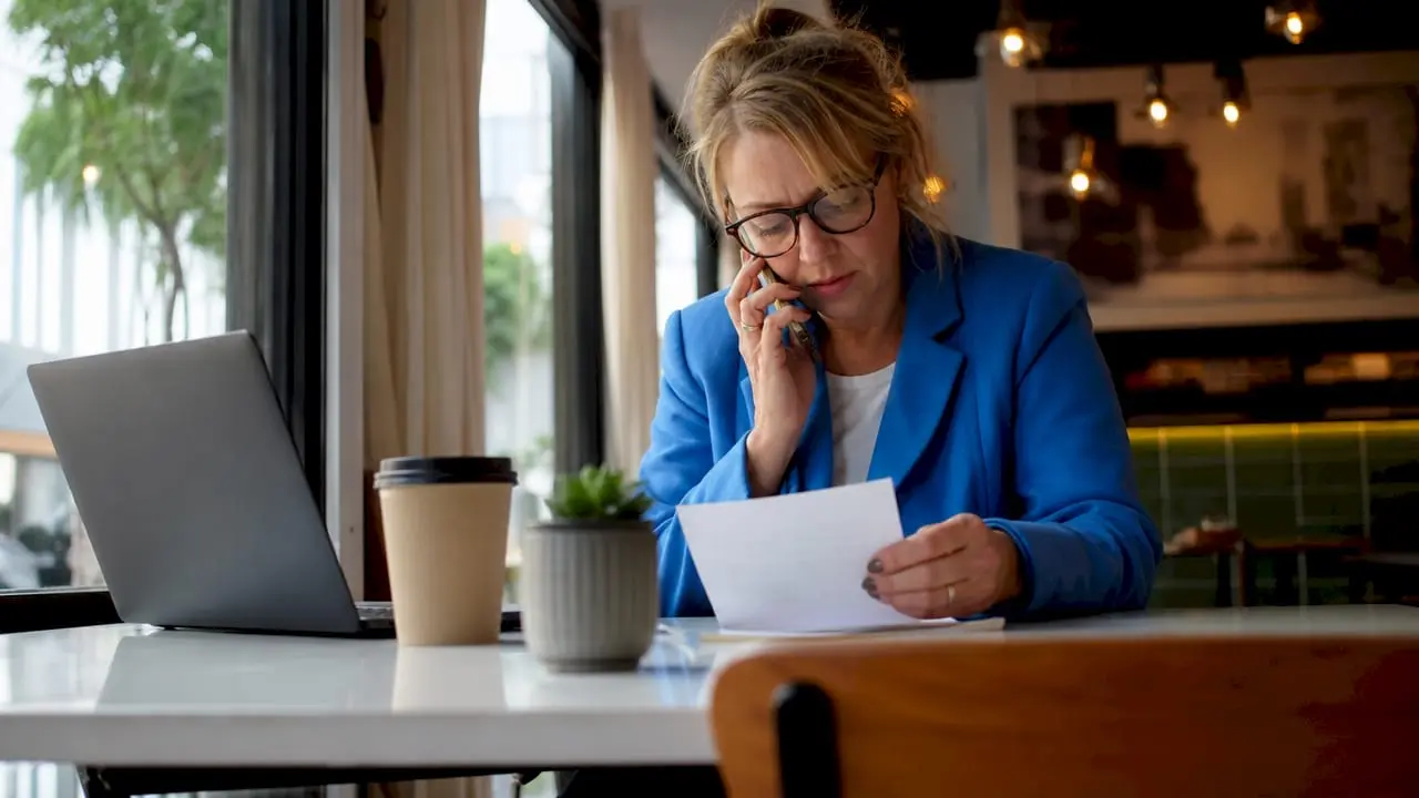 Businesswoman dialing memorable UK contact number