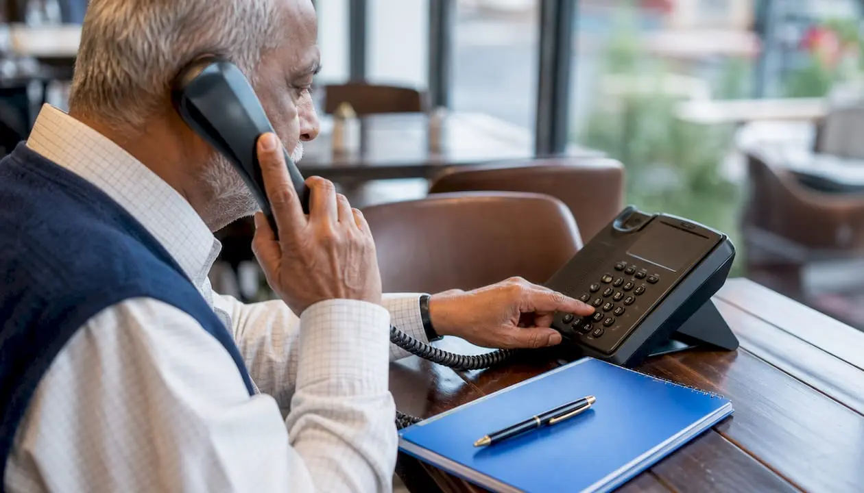 Hands activating call forwarding on office phone