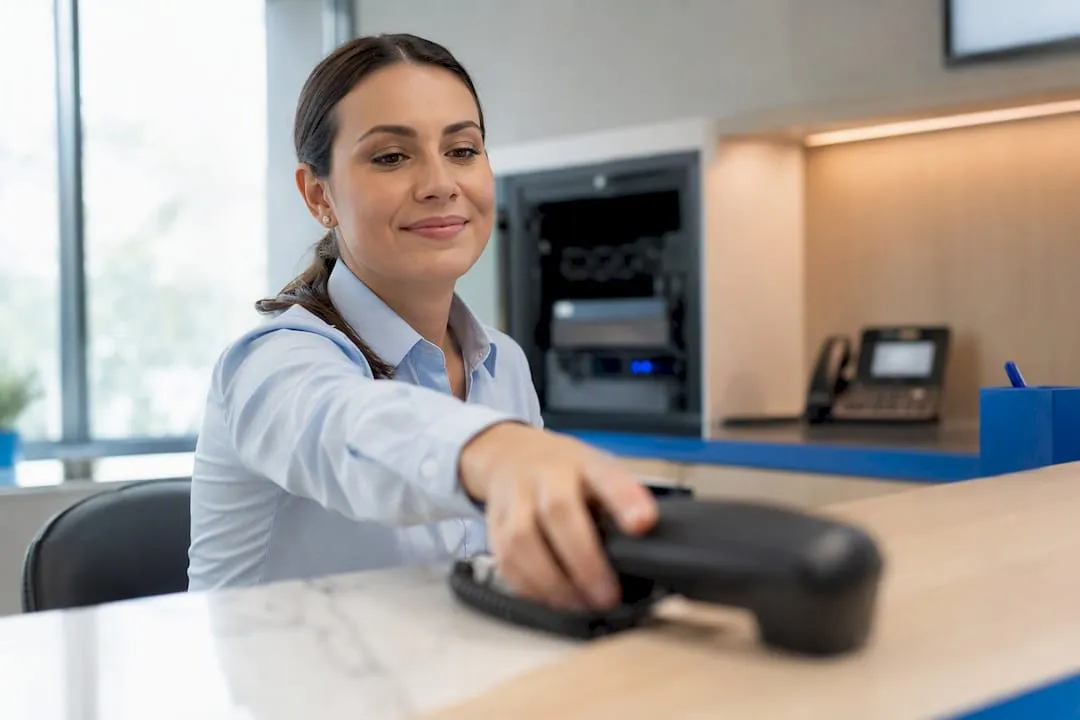 UK receptionist answering a business call